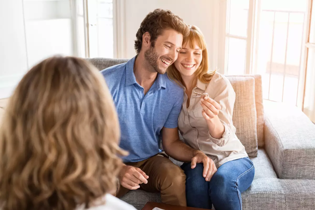 Saleswoman giving apartment keys to homeowners Saleswoman giving apartment keys to homeowners